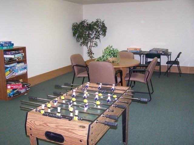 a game table in a room with chairs