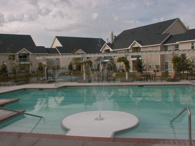 a large swimming pool with a building in the background