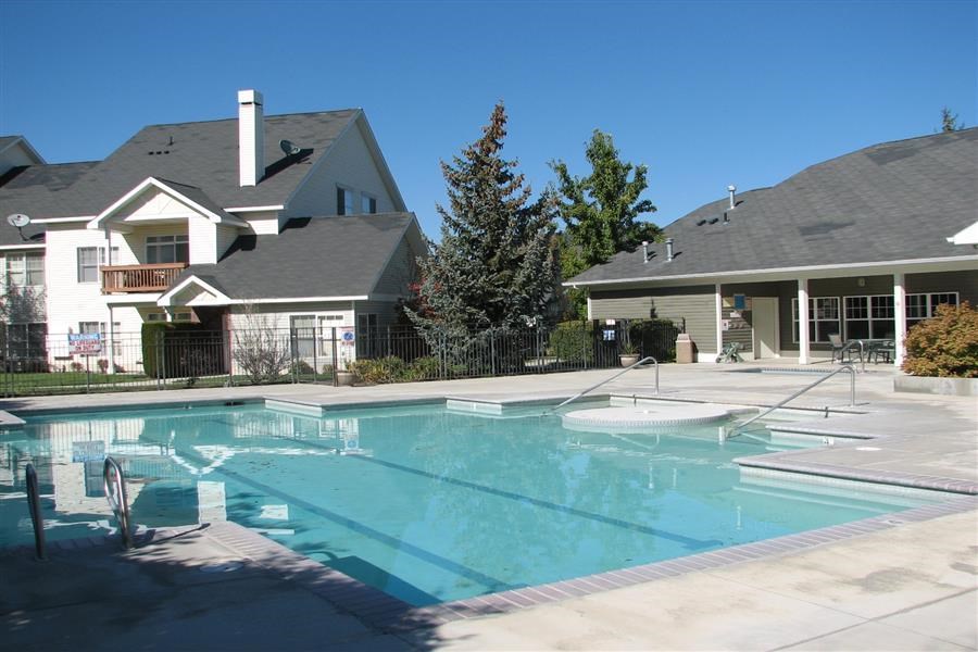 a large swimming pool in front of a house