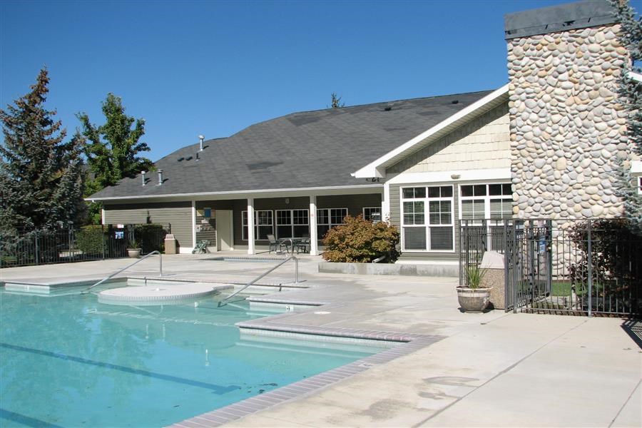 a swimming pool in front of a house