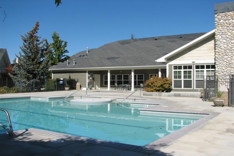 a swimming pool in front of a house