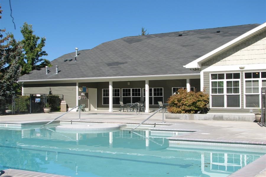 a swimming pool in front of a house