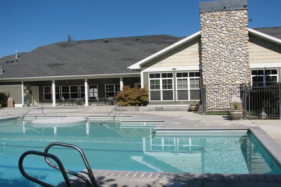 a swimming pool in front of a house