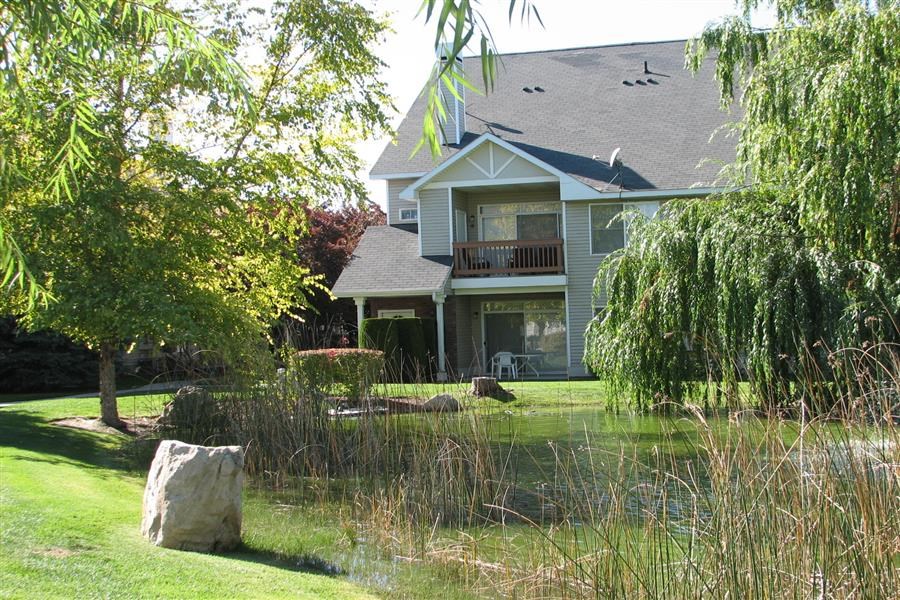 a house with a pond in front of it