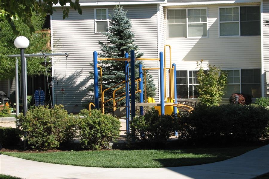 a playground in front of a white house