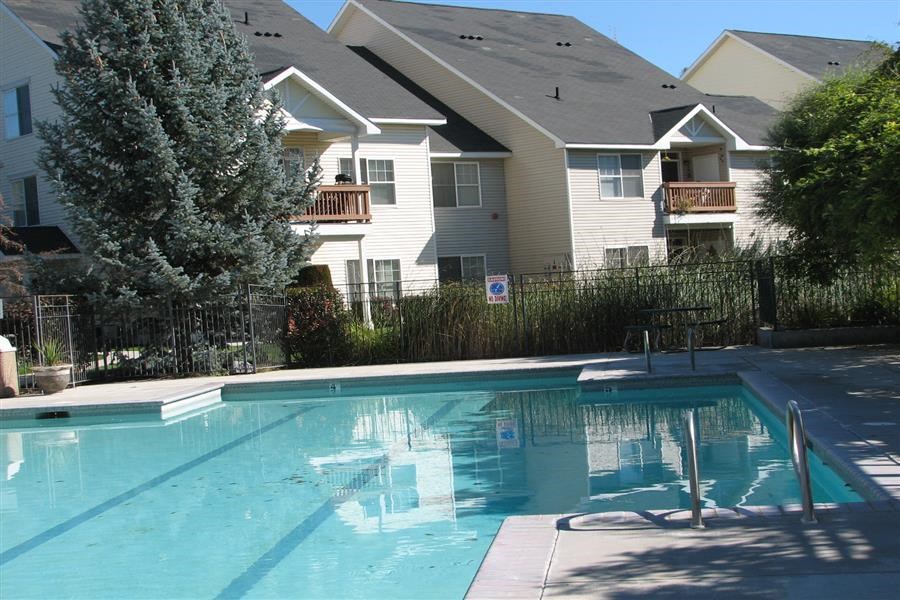 a swimming pool with a house in the background