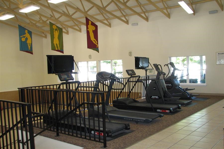 a workout room with weights and a treadmill