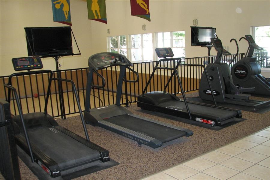 a group of exercise machines in a room
