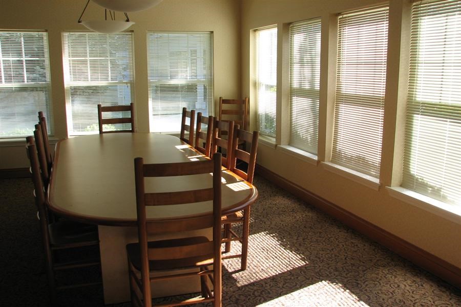 a dining room with a table and chairs