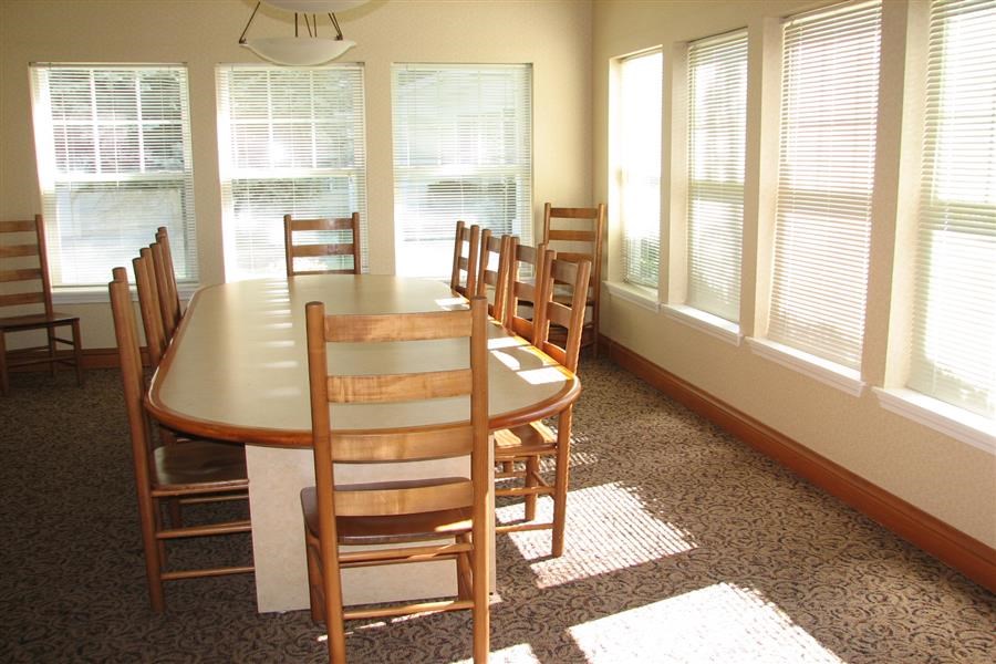 a dining room with a wooden table and chairs