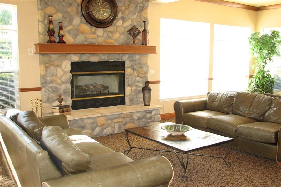 a living room with leather furniture and a fireplace