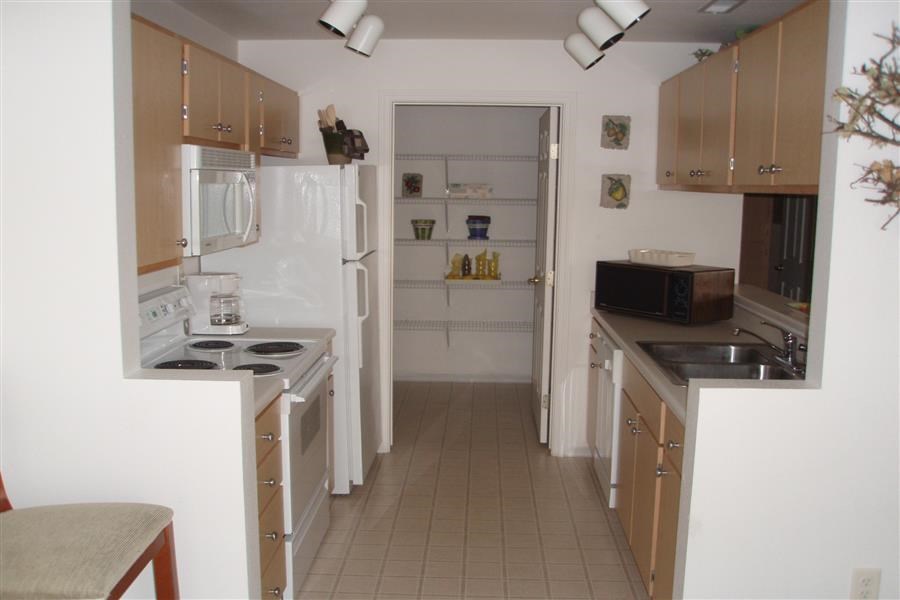 a small kitchen with a stove and a refrigerator