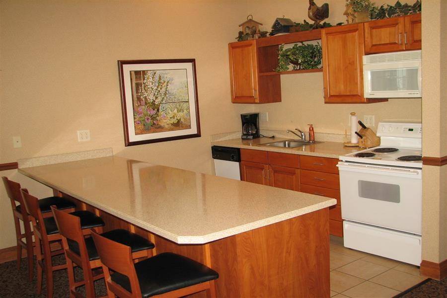 a kitchen with a counter and chairs