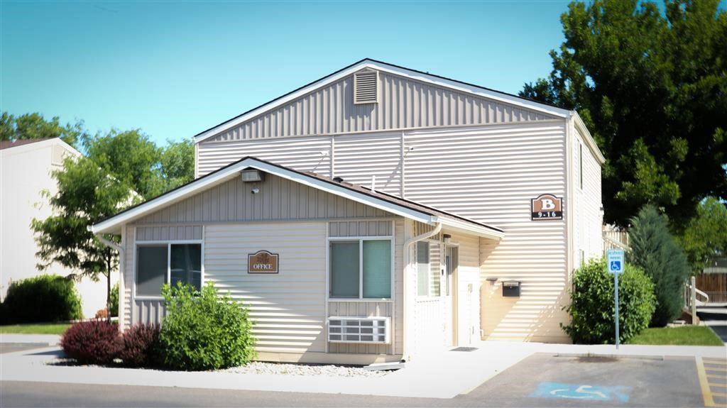 a white church with a sign on the side of a building