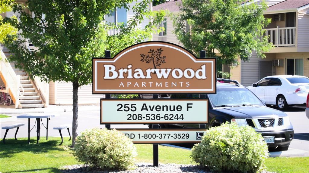 a sign for birwood apartments in front of a parking lot