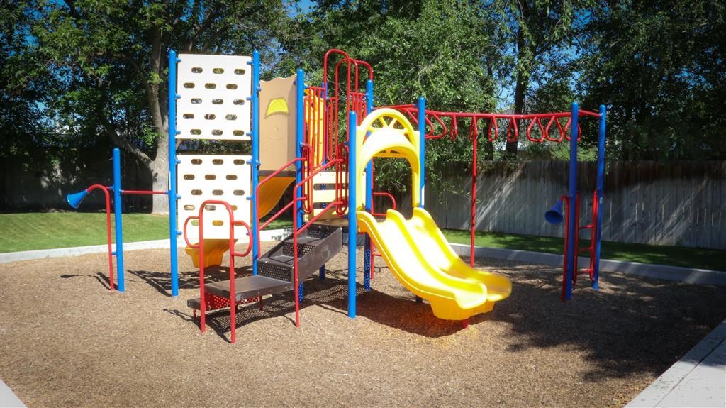 a playground with a swing set and slides