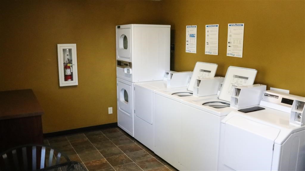 a laundry room with washing machines and dryers