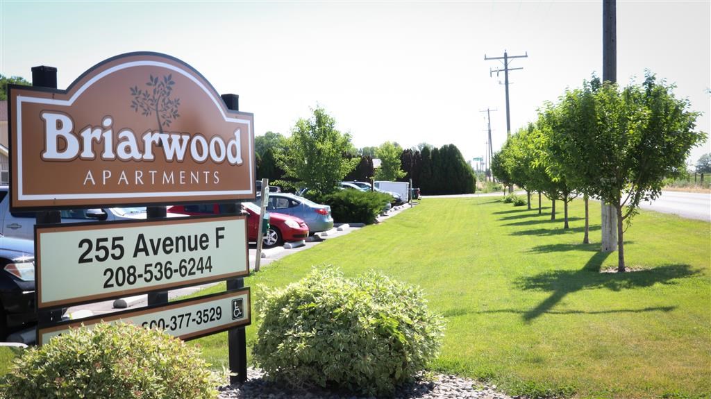 a sign for the birrwood apartments on the side of the road