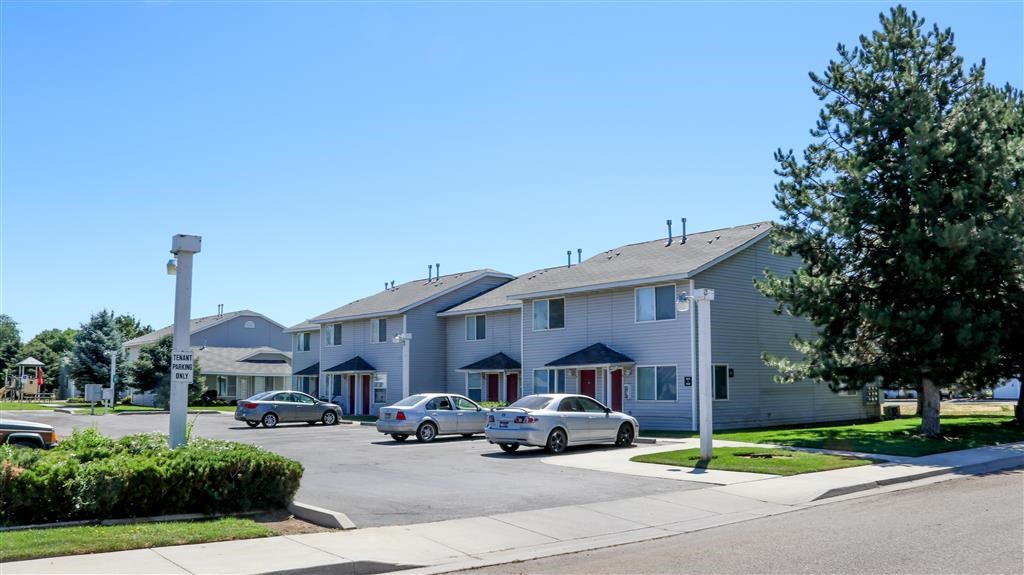 a street with cars parked in front of houses