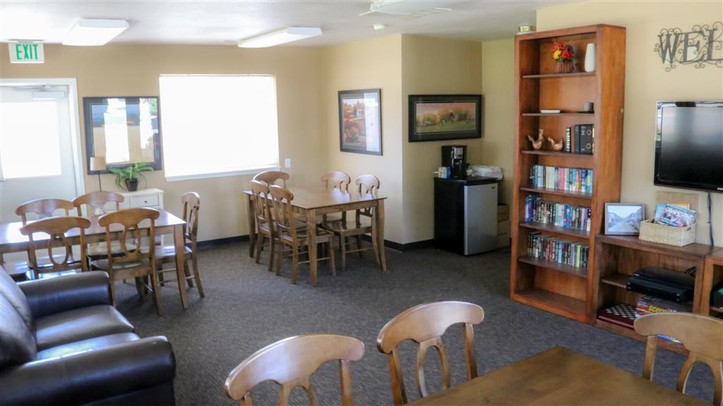 a living room with a table and chairs and a television