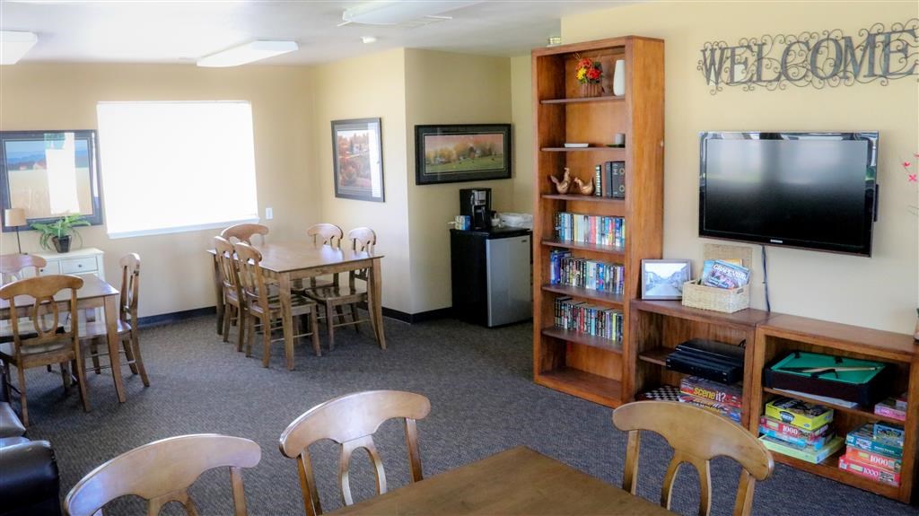 a living room with a table and chairs and a television