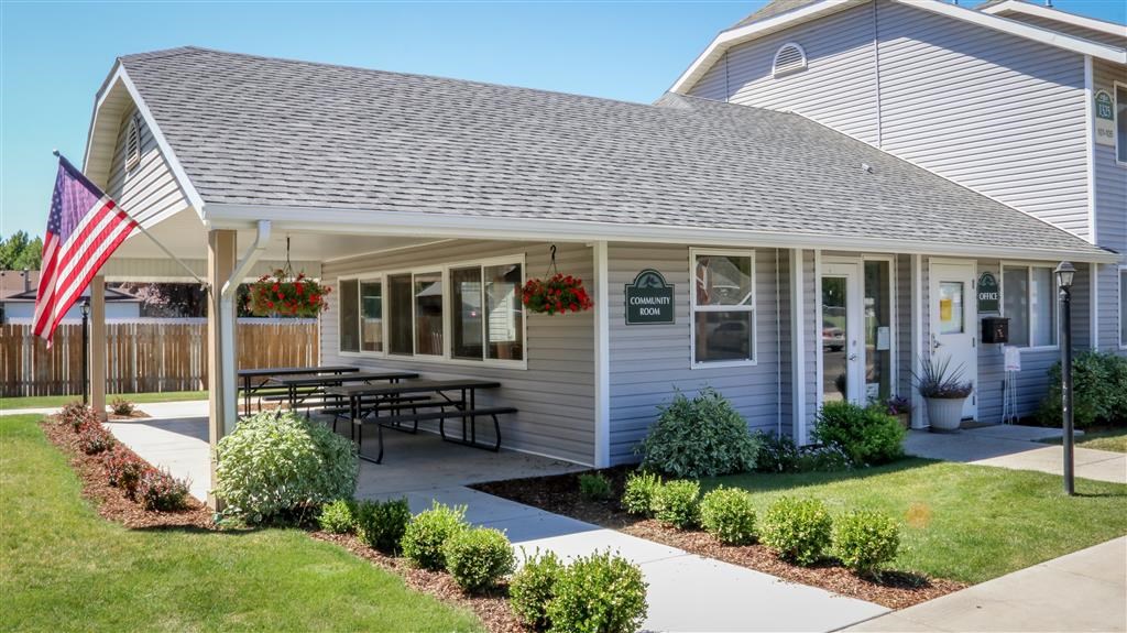 a patio in front of a house with an flag