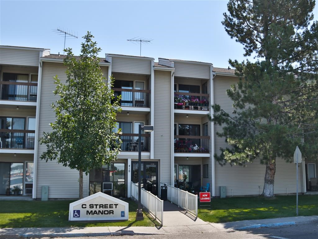 an apartment building with a street sign in front of it