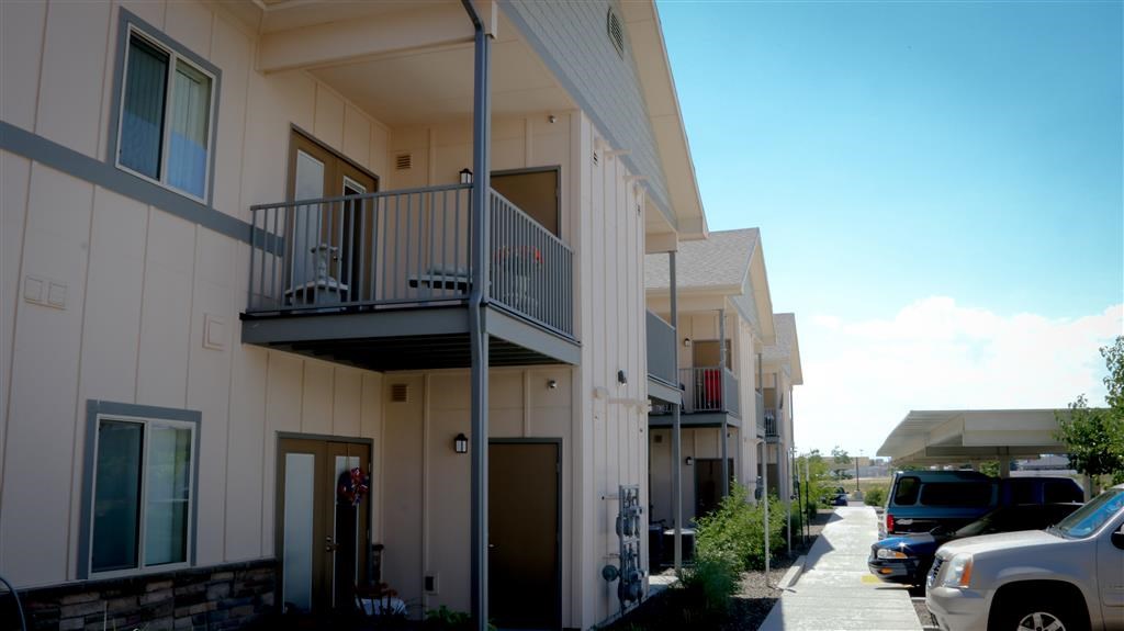 an apartment building with cars parked in front of it