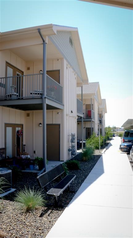 a row of houses with benches in front of them