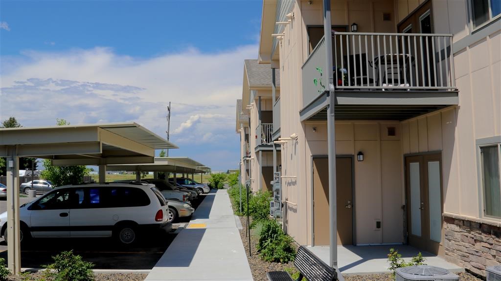 a row of buildings with cars parked in front of them