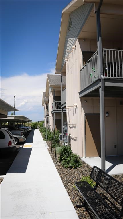 a bench sitting on a sidewalk in front of a building