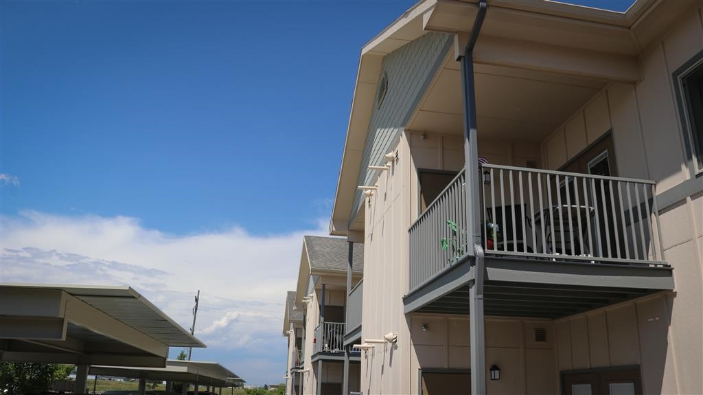 a building with a balcony and a blue sky