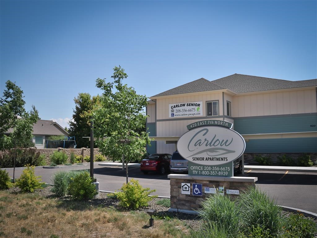 a building with a sign in front of a parking lot
