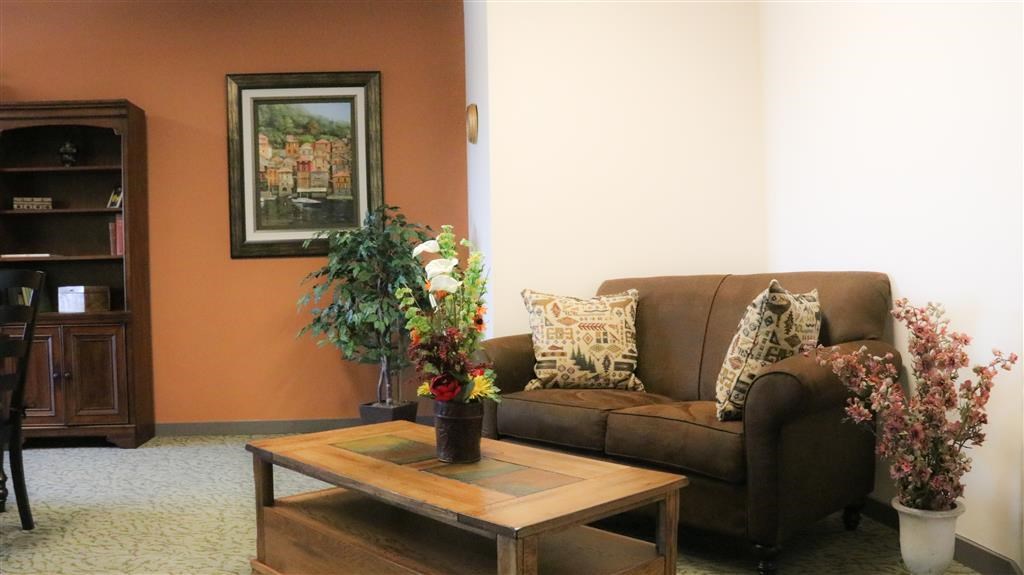 a living room with a couch and a table with flowers