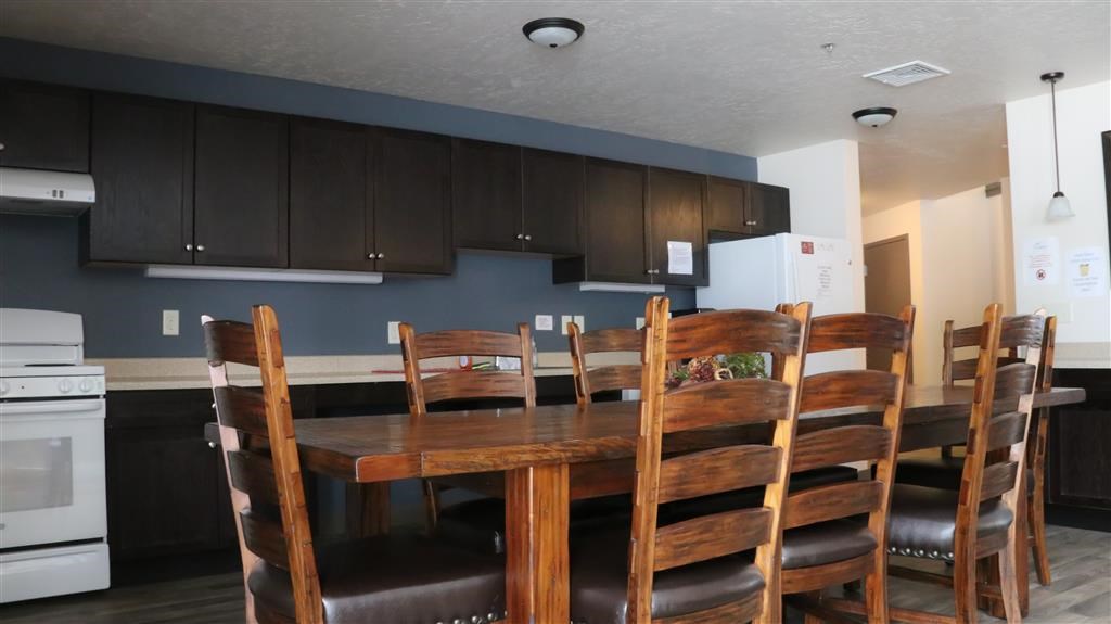 a kitchen with a wooden table and chairs