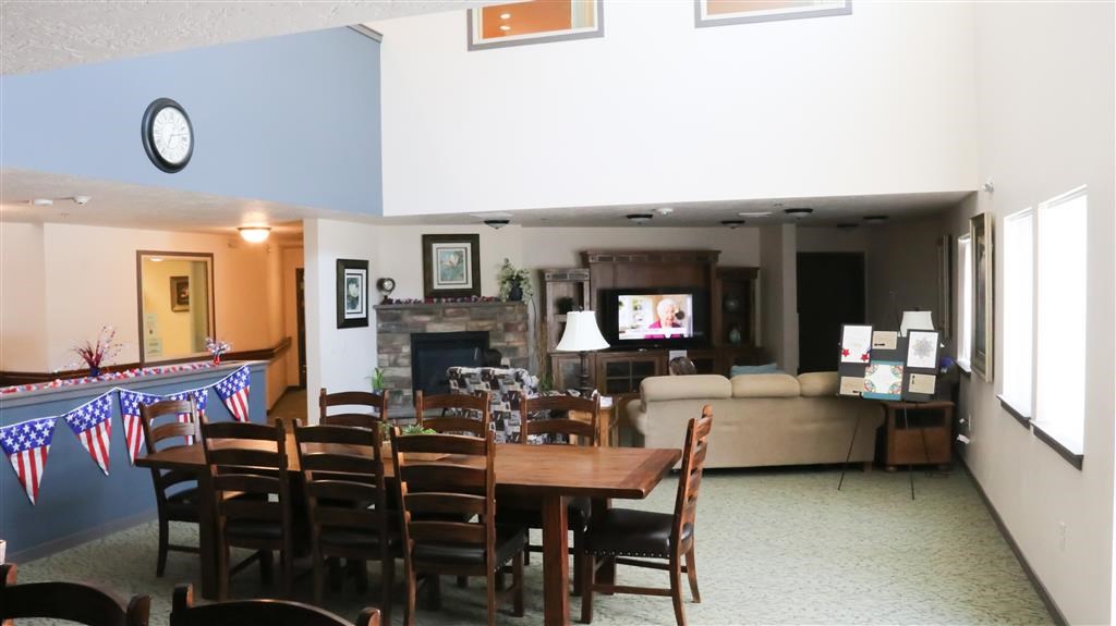 a dining room and living room with a table and chairs