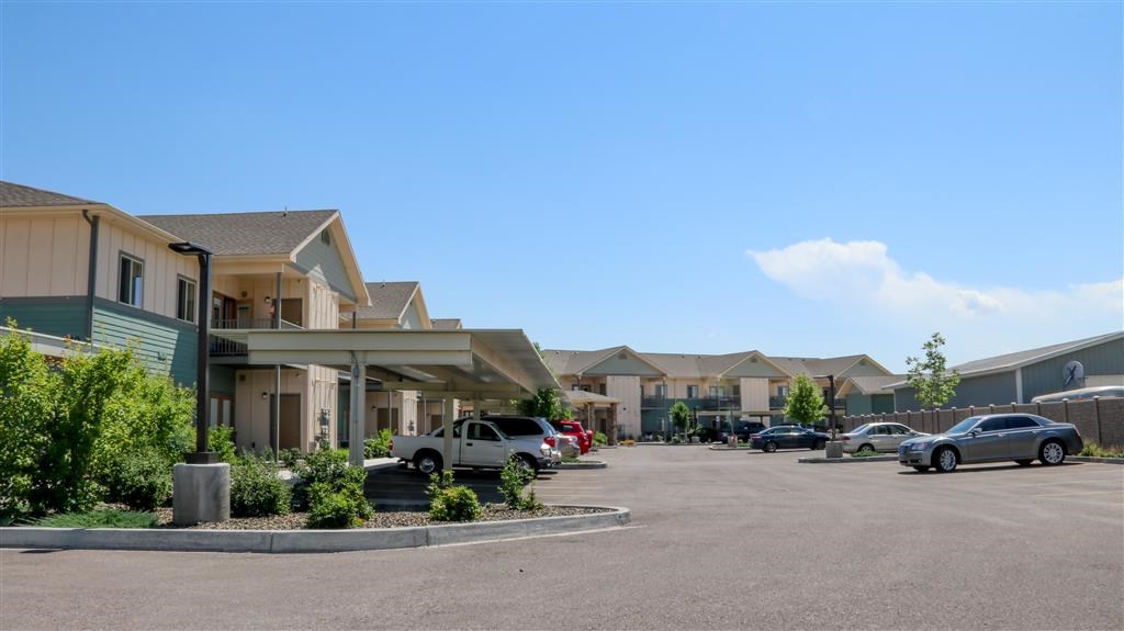 a parking lot filled with cars in front of houses