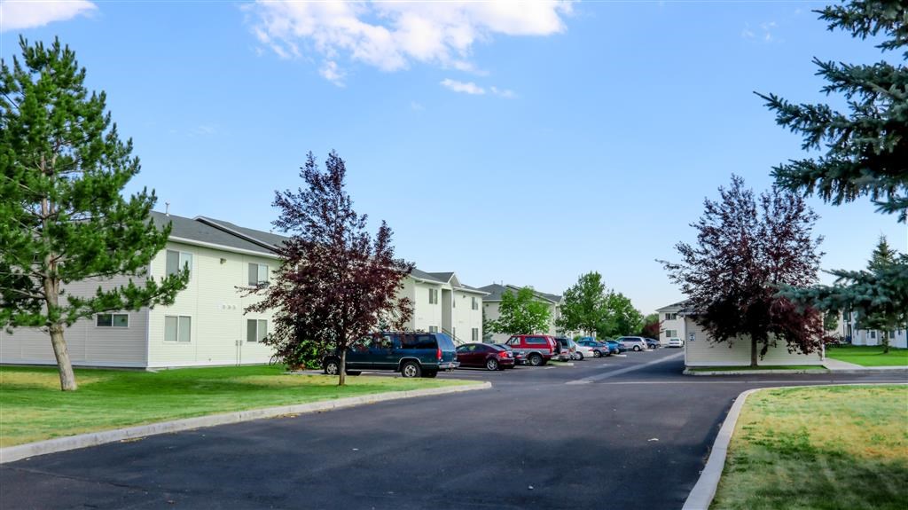 a street with cars parked in front of houses