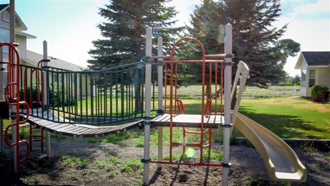 a swing set and slide in a playground