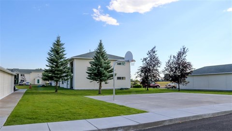 a house with a driveway and a yard in front of it
