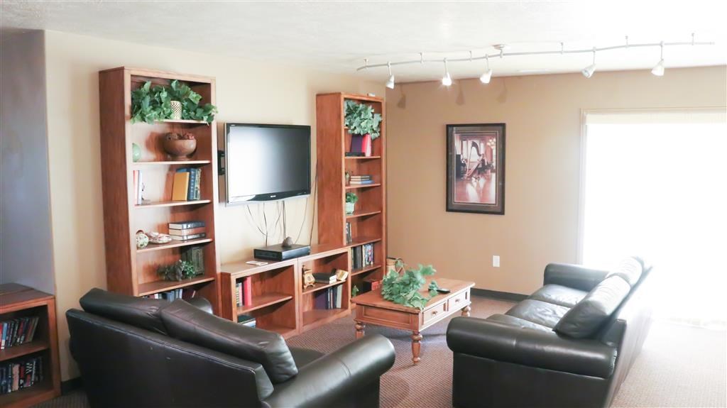 a living room with leather furniture and a television