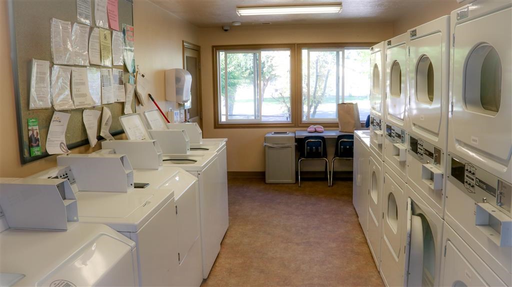 a laundry room filled with washing machines and dryers