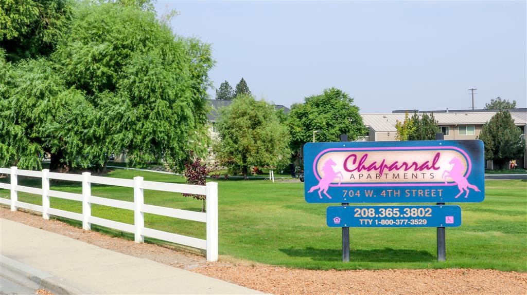 a sign for a restaurant on the side of a field
