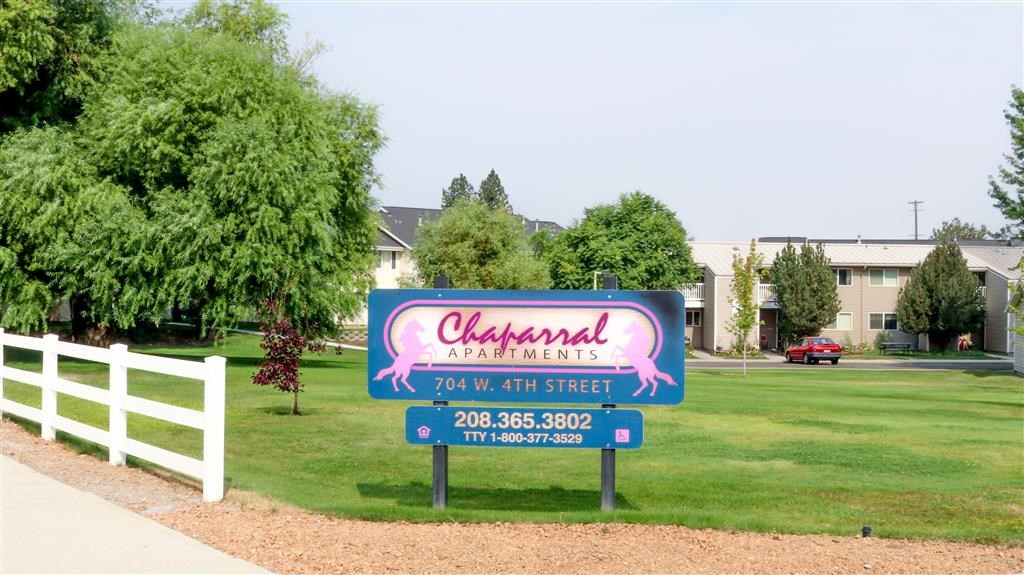 a sign for a restaurant on the lawn of a street