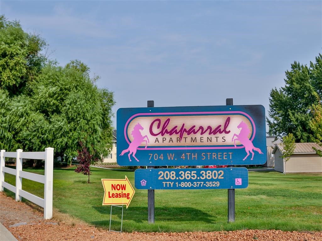 a sign for the champlin apartments on the side of the road