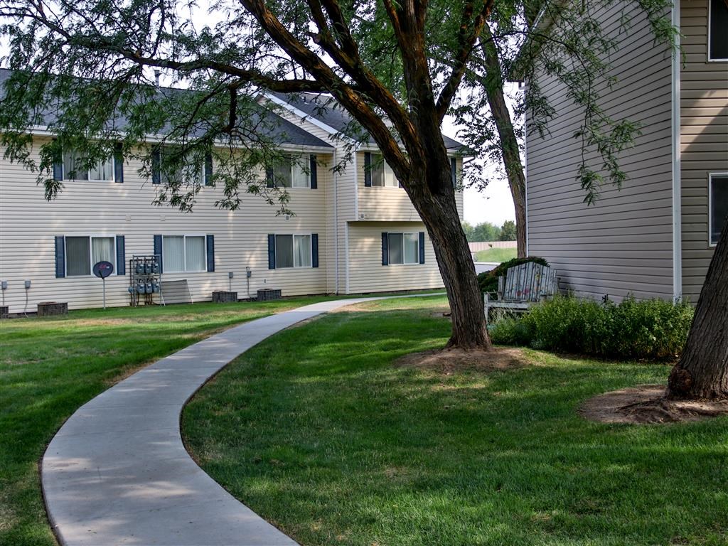 a curved sidewalk in front of an apartment building