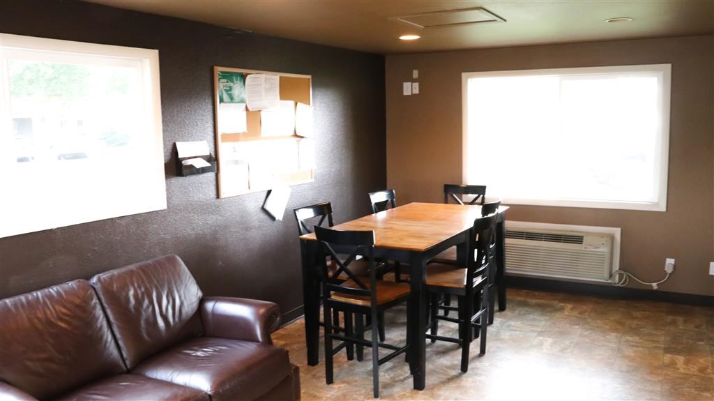 a living room with a wooden table and leather furniture