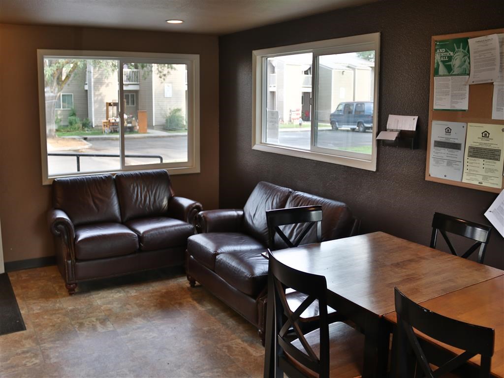a living room with leather couches and a table