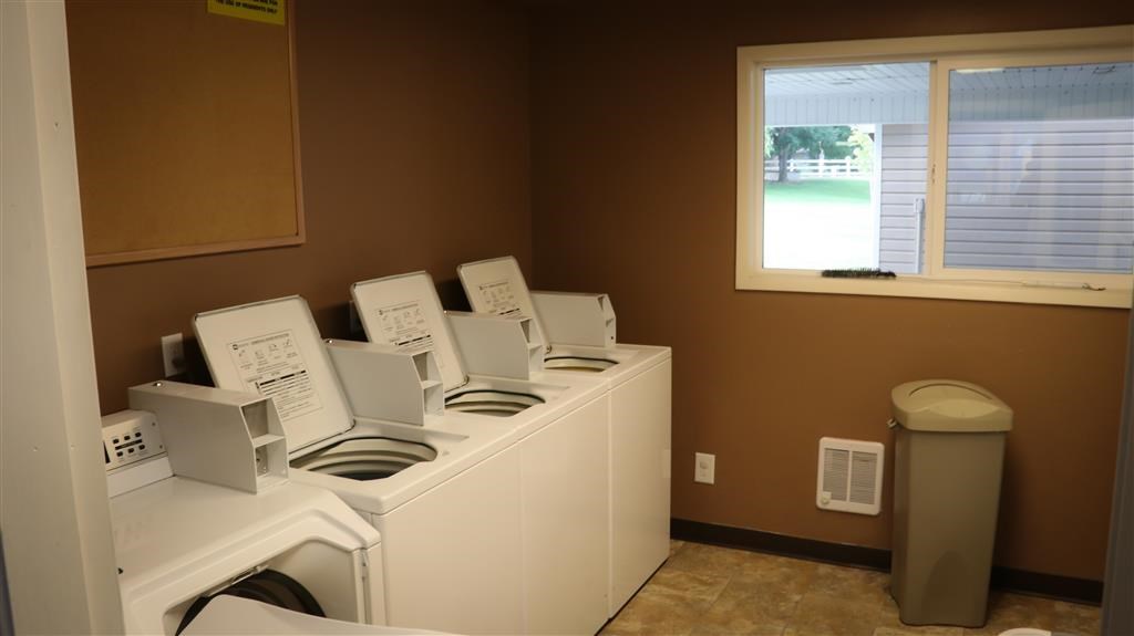 a laundry room with washing machines and a window