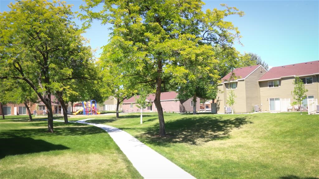 a sidewalk in the middle of a park